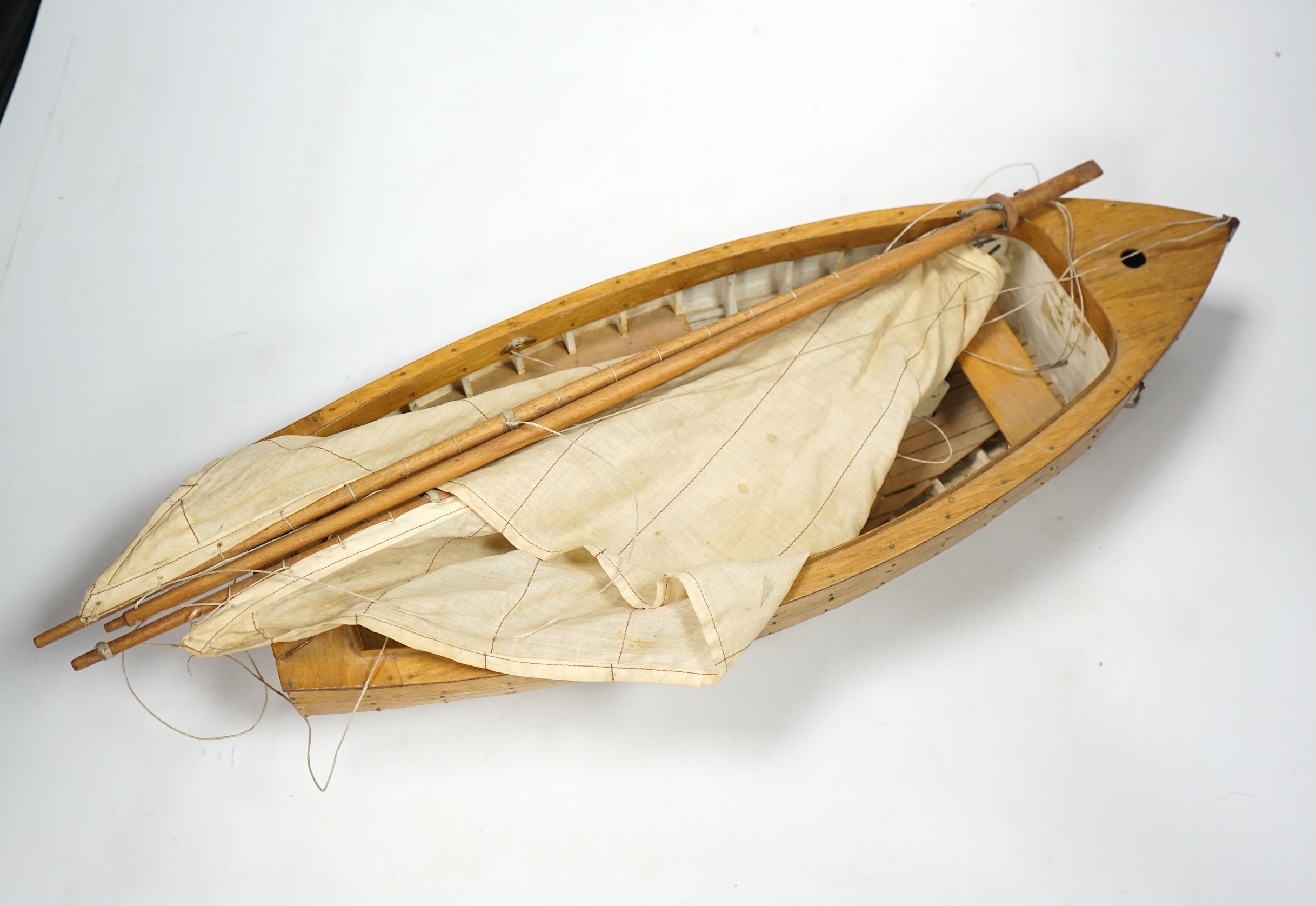 A mid 20th century kit built wooden model sailing boat, ‘Rob’, of plank on frame construction with white painted interior, hull 45cm long. Condition - fair to good.